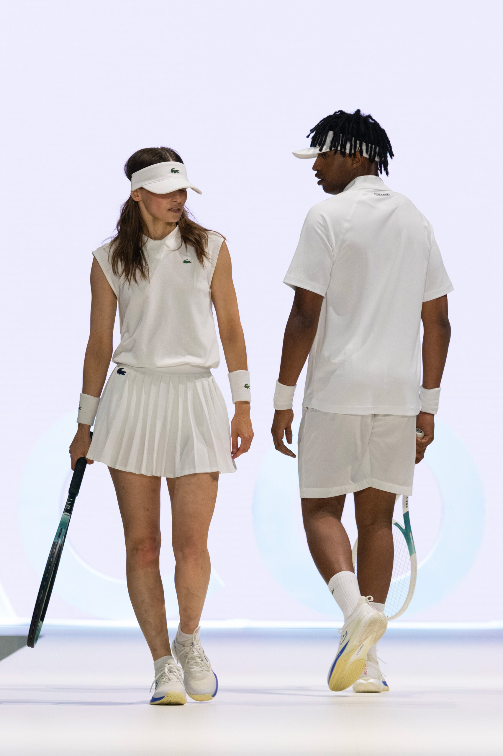 Lacoste SS24 brand activation performers dressed in tennis outfits during the fashion show concept by Golden Mama
