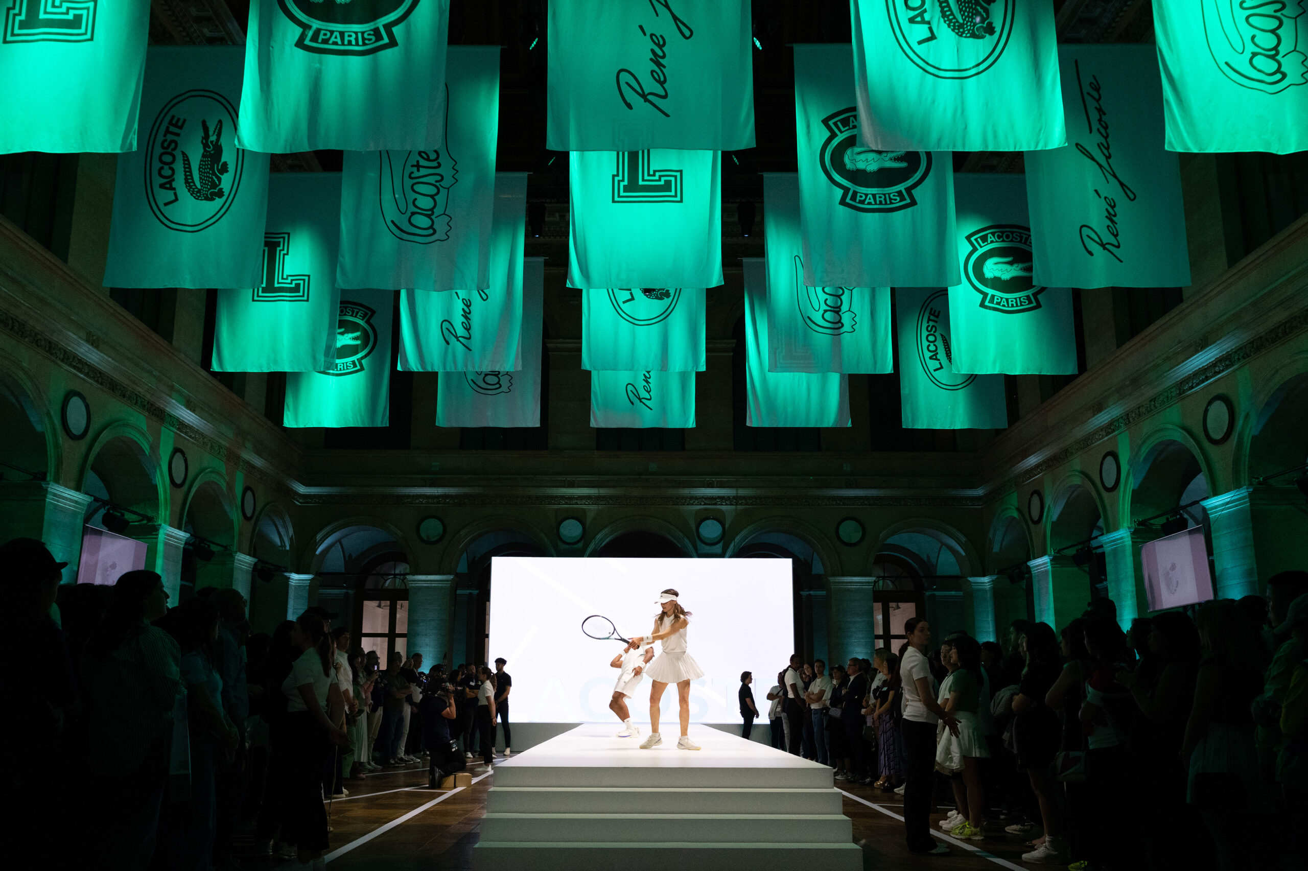 Lacoste SS24 brand activation performers dressed in tennis outfits during the fashion show concept by Golden Mama