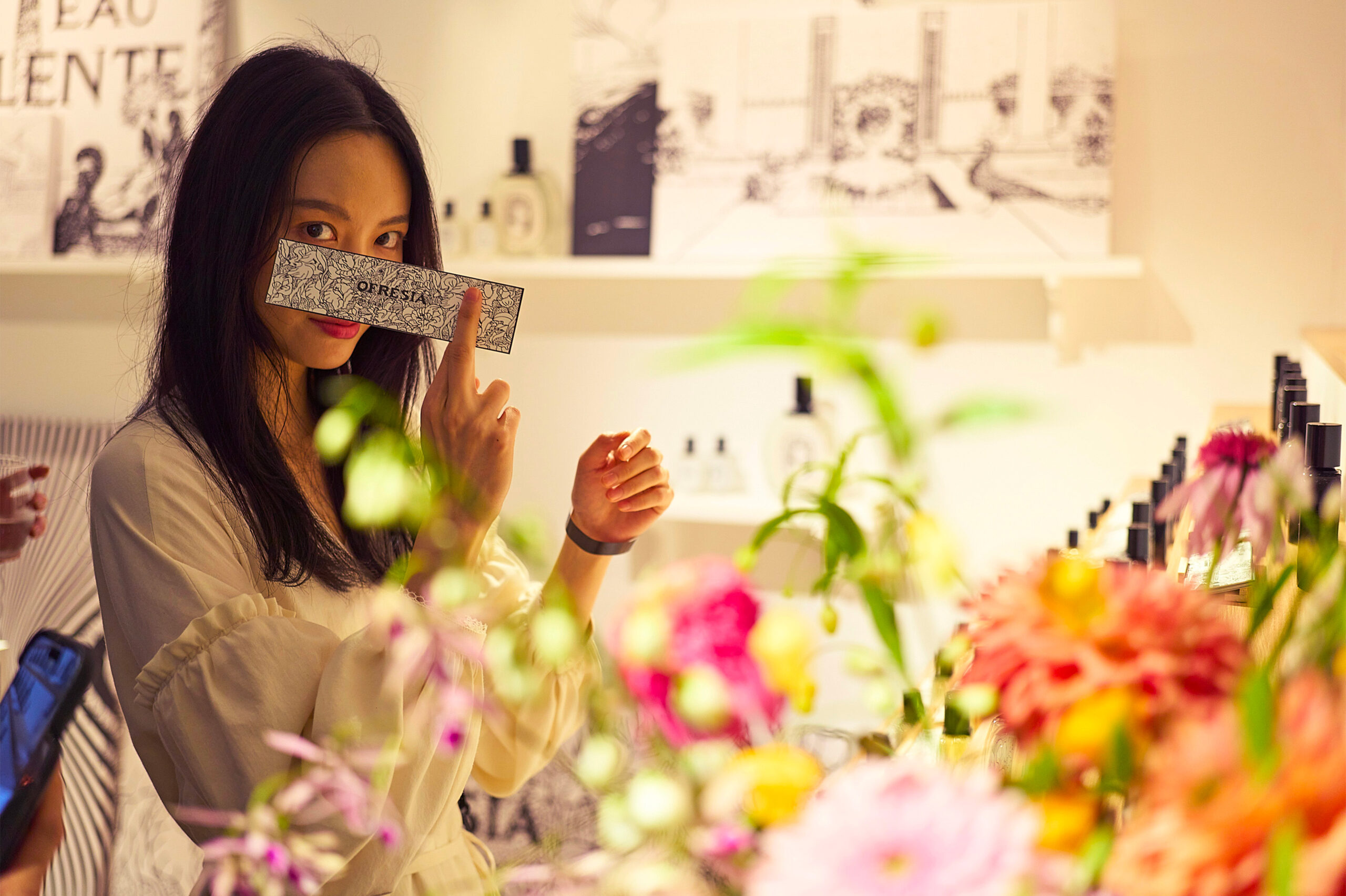 Diptyque Un Air de Paris Ofresta perfumes and scented candles being tried by an influencer amidst flowers by Golden Mama